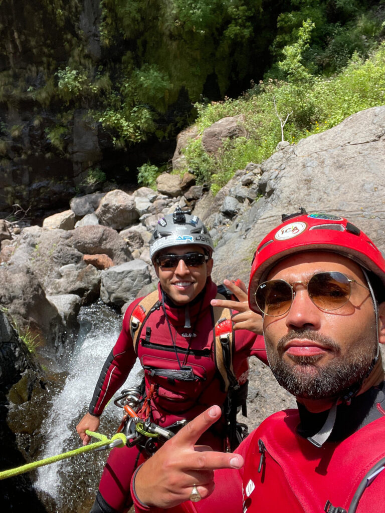 Two Go Explore Madeira instructors flash peace signs by a stream in Ribeira do Cidrão, Nuns Valley, ready for Intermediate Level 2 canyoning adventures.