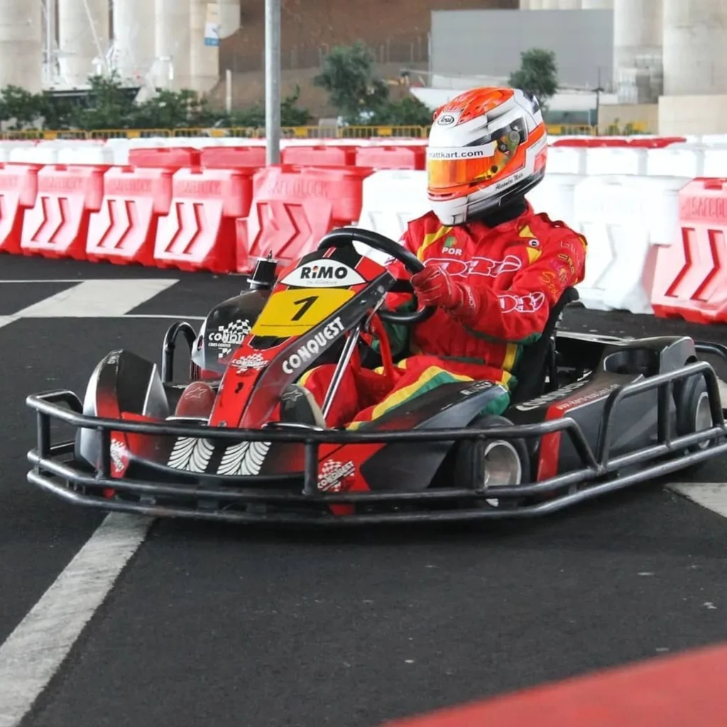 A Person with a red suit having fun and driving a Kart, under Madeira Airport, an experience by Go Kart Madeira