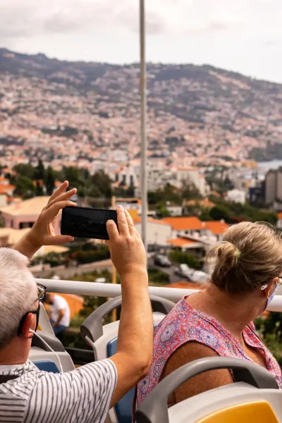 People taking a photo on the top of the bus in Funchal a Hop-on Hop-off Bus experience by Carristur