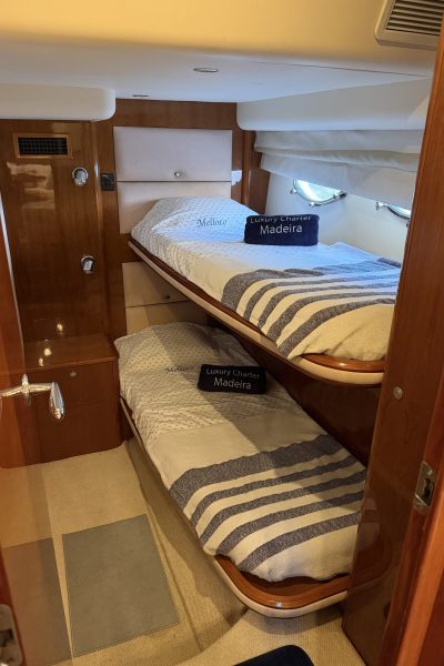 Inside of a room with a bunk bed of a Luxury Madeira Yacht Charter Rental by Luxury Charter Madeira.