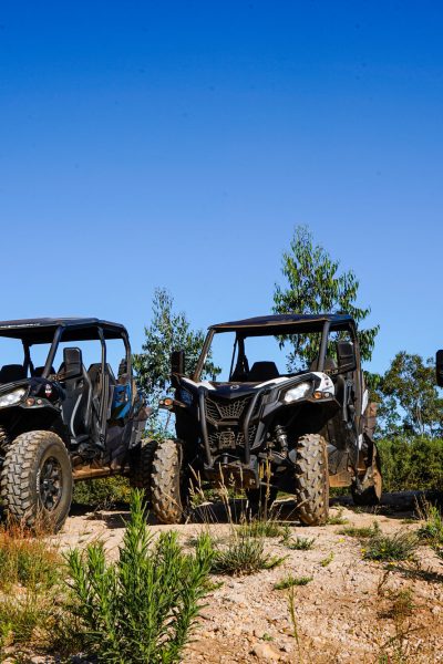 Row of off-road buggies parked on a dirt hill under a clear blue sky, ready for an adventure buggy tour by Buggy Funtrip Madeira