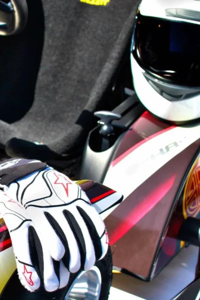Close up of some gloves, an helment and a karting car from Go Kart Madeira.