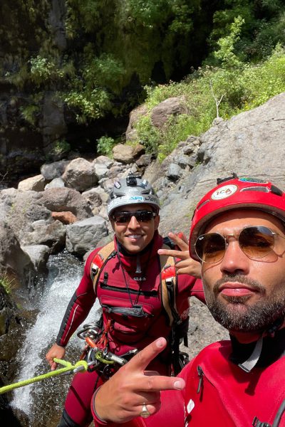 Two Go Explore Madeira instructors flash peace signs by a stream in Ribeira do Cidrão, Nuns Valley, ready for Intermediate Level 2 canyoning adventures.