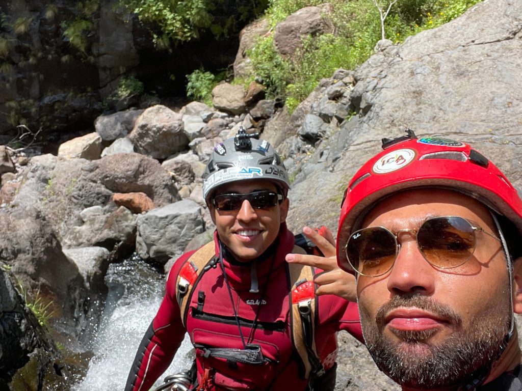 Two Go Explore Madeira instructors flash peace signs by a stream in Ribeira do Cidrão, Nuns Valley, ready for Intermediate Level 2 canyoning adventures.