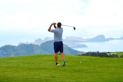 A golf player playing golf at Santo da Serra Golf in Madeira Island