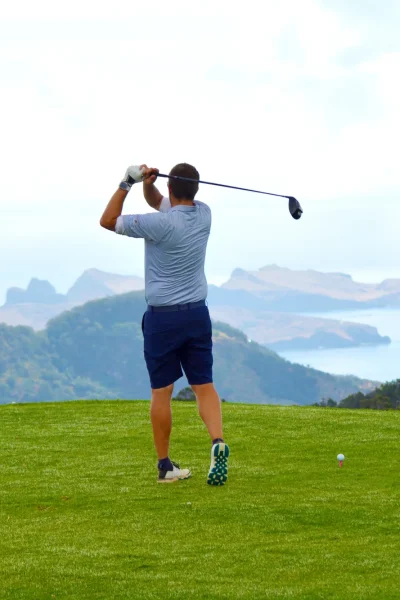 A golf player playing golf at Santo da Serra Golf in Madeira Island
