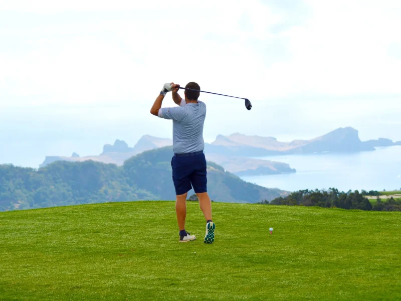A golf player playing golf at Santo da Serra Golf in Madeira Island