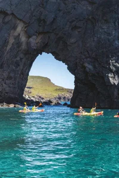 Multiple people in Kayaks cruising in the sea of Ponta de São Lourenço, an experience by Madeira Sea Emotions.
