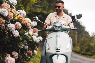 A man cruising in a vespa guided moutain tour.The type of scooter offered for rent to explore the Madeira island’s winding mountain roads and scenic viewpoints by Vespa Madeira Scooter Rent.