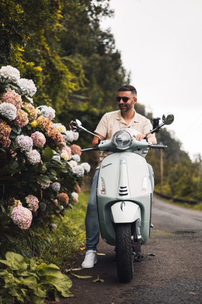 A man cruising in a vespa guided moutain tour.The type of scooter offered for rent to explore the Madeira island’s winding mountain roads and scenic viewpoints by Vespa Madeira Scooter Rent.