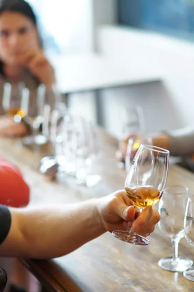 Young man savoring a glass of Madeira wine during a group tasting session, an experience by Wine Tours Madeira