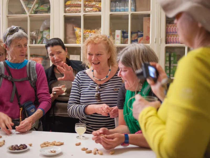 Couple tasting artisanal chocolates during the Wine and Food Walking Tour in Funchal, an experience by Wine Tours Madeira.