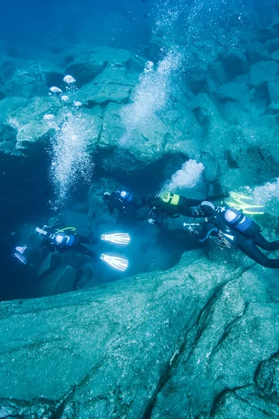 Divers exploring some underwater cave in Madeira