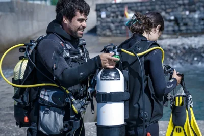 Dive instructor preparing a female diver for a Try Scuba Diving experience in Madeira, Portugal.